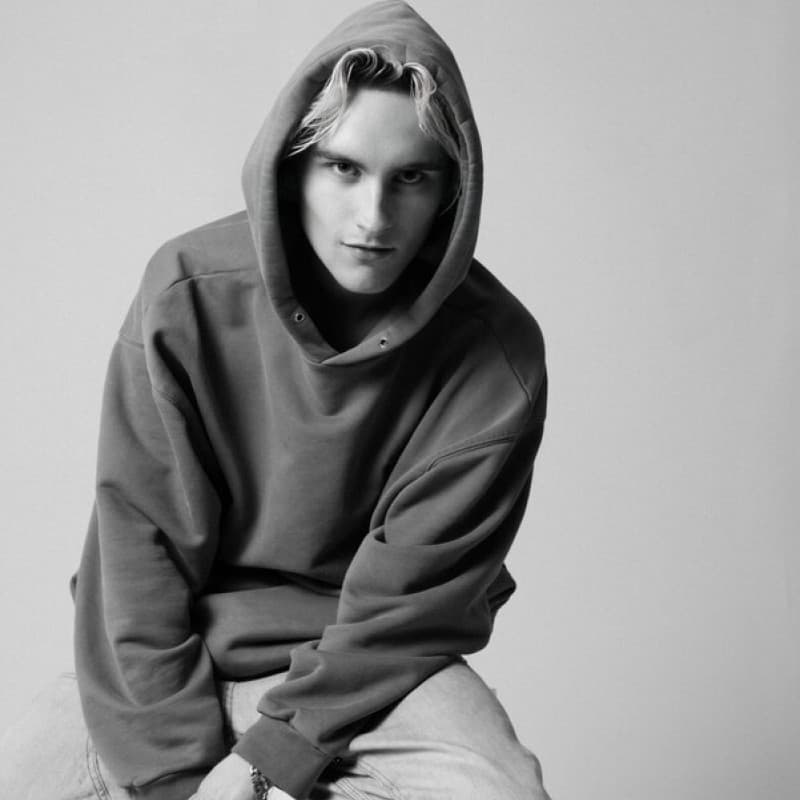 Black and white portrait of Oliver Heeck wearing a hooded sweatshirt