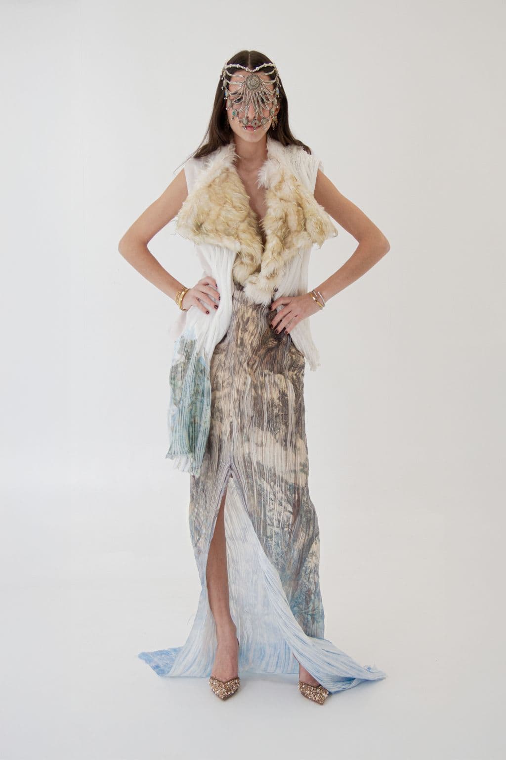 Model in a pale layered fragrance-inspired look with jeweled face piece
